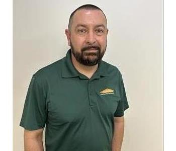 male SERVPRO employee holding SERVPRO equipment 