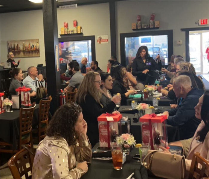 multiple people sitting in a resturant eating lunch 